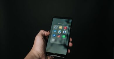photo of hand holding a black smartphone