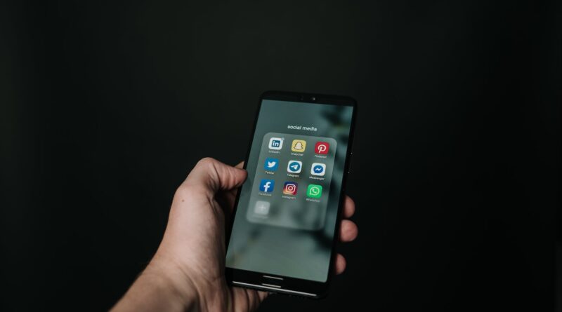 photo of hand holding a black smartphone